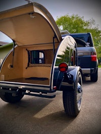 a camper trailer with a bed in the back