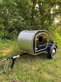 a small trailer with a camper attached to it
